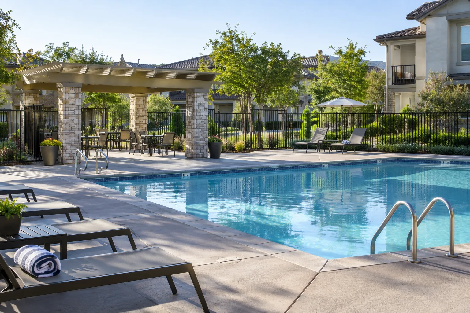 residential community pool with secure fence and orderly common area