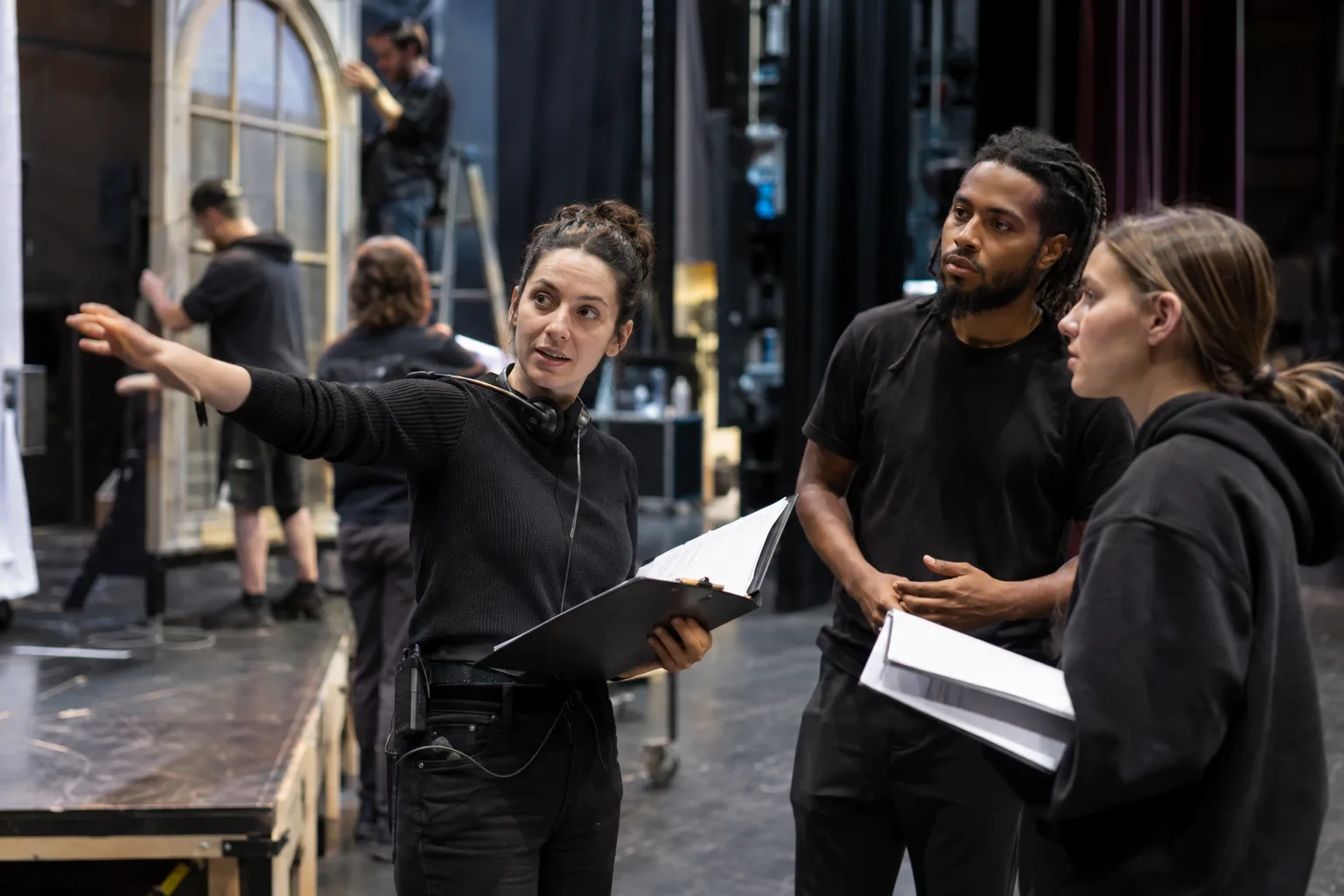 stage manager coordinating rehearsal with theater crew